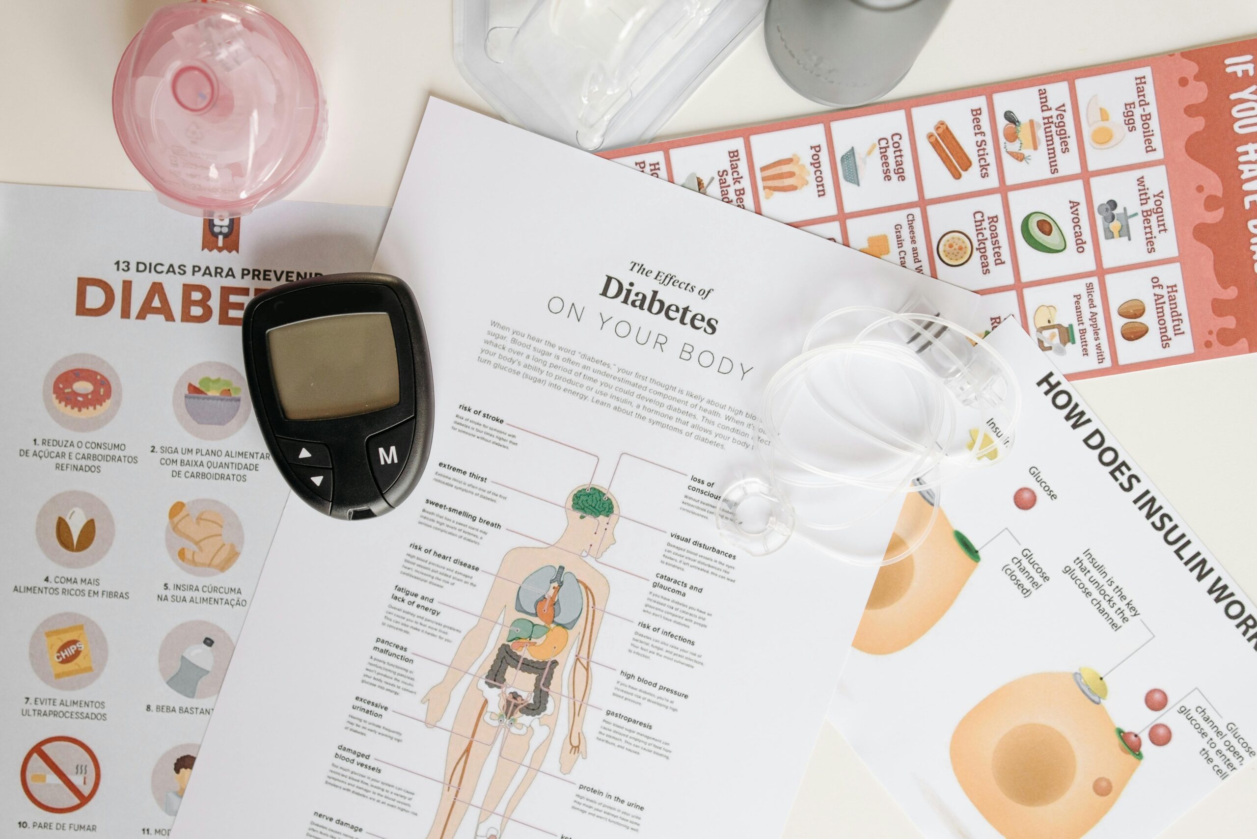 Close-up of diabetes management tools and informational documents on a table.